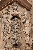 Chiang Mai - The Wat Phra Singh temple. The ho trai (temple library). The stucco figures in high relief of the base showing dancing Devas. 